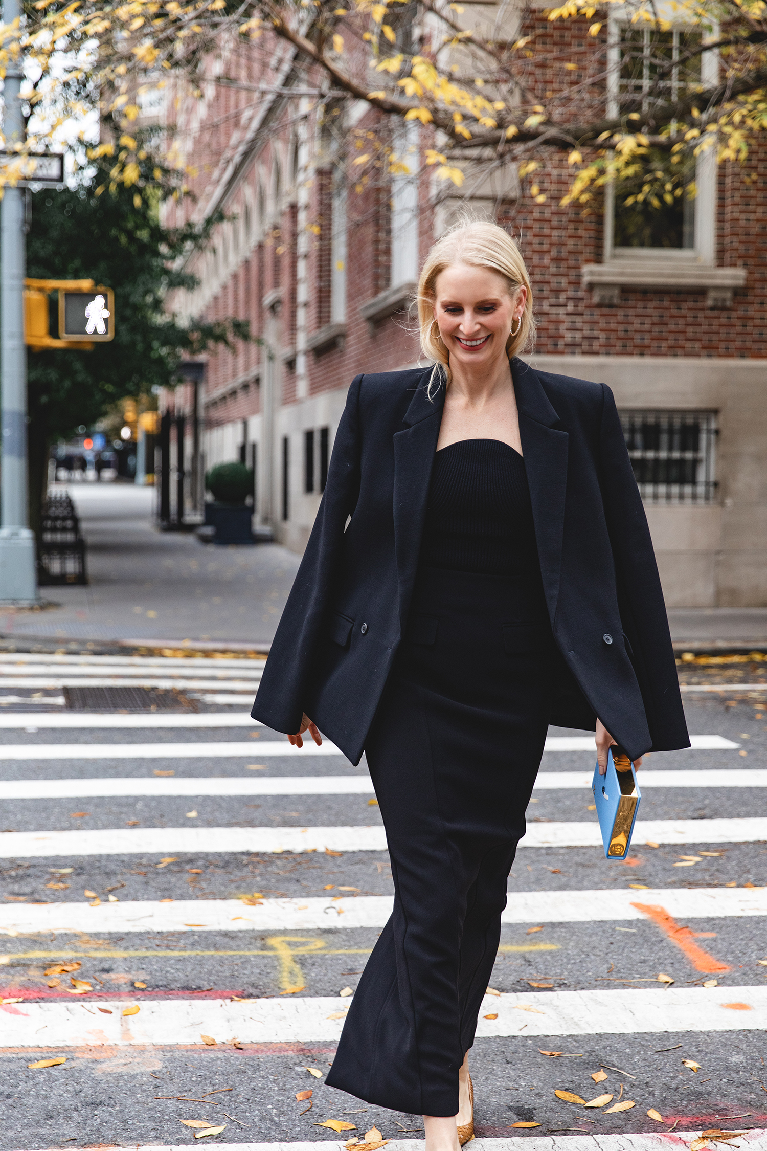 Merritt Beck in a Toteme Suiting Skirt, Olympia Le-Tan Caviar Embroidered Clutch and The Row Liisa Python Pumps