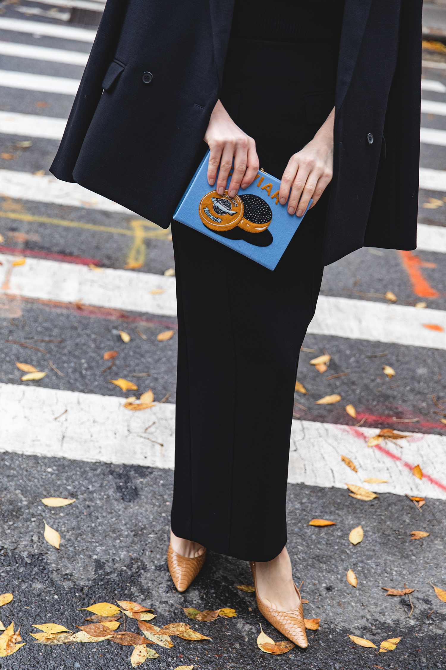 Merritt Beck in a Toteme Suiting Skirt, Olympia Le-Tan Caviar Embroidered Clutch and The Row Liisa Python Pumps
