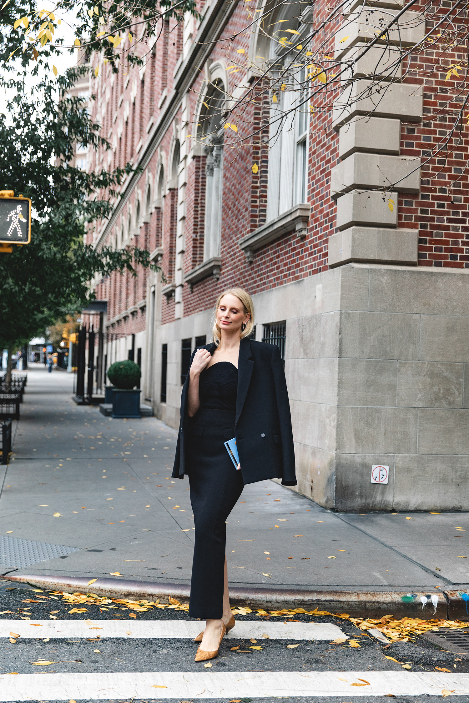 Merritt Beck in a Toteme Suiting Skirt, Olympia Le-Tan Caviar Embroidered Clutch and The Row Liisa Python Pumps